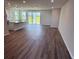 Open-concept living area with wood floors and sliding glass doors to the outdoors at 18146 Beach Ranch Ter, Lakewood Ranch, FL 34211