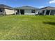 Expansive backyard with lush green lawn, providing ample space for outdoor activities and relaxation at 18204 Beach Ranch Ter, Lakewood Ranch, FL 34211