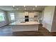 Bright kitchen featuring white cabinets, stainless steel appliances, granite countertops, and a large central island at 18204 Beach Ranch Ter, Lakewood Ranch, FL 34211