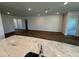 Spacious living area showcasing wood floors with views of the large center island and an open concept design at 18204 Beach Ranch Ter, Lakewood Ranch, FL 34211