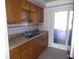 Kitchen with wood cabinets, tile floor, and stainless steel appliances at 1433 S Belcher Rd # A9, Clearwater, FL 33764