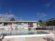 Relaxing community pool with lounge chairs at 1433 S Belcher Rd # A9, Clearwater, FL 33764