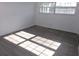 Sunny bedroom with gray flooring and large windows at 1433 S Belcher Rd # A8, Clearwater, FL 33764