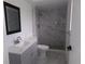 Updated bathroom with gray tiled shower and gray vanity at 1433 S Belcher Rd # A8, Clearwater, FL 33764