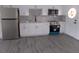 Modern white kitchen featuring stainless steel appliances and gray flooring at 1433 S Belcher Rd # A8, Clearwater, FL 33764