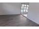 Spacious bedroom with gray flooring and sliding glass doors leading to a patio at 1433 S Belcher Rd # A8, Clearwater, FL 33764