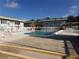 Community pool with surrounding patio furniture at 1433 S Belcher Rd # A8, Clearwater, FL 33764