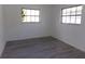 Bright bedroom with gray flooring and two windows at 1433 S Belcher Rd # A8, Clearwater, FL 33764