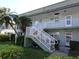 Two-story building with stairs and lush landscaping at 1433 S Belcher Rd # A8, Clearwater, FL 33764