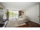 Relaxing living room with sectional sofa, hardwood floors, and access to balcony at 2630 Pearce Dr # 404, Clearwater, FL 33764