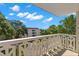 Private balcony overlooking lush trees and a partial view of the community at 2630 Pearce Dr # 404, Clearwater, FL 33764