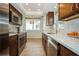 Modern kitchen with stainless steel appliances and light tile floor at 2630 Pearce Dr # 404, Clearwater, FL 33764