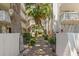 Pathway to condo building with lush landscaping and gates at 2630 Pearce Dr # 404, Clearwater, FL 33764