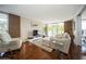 Spacious living room with hardwood floors, comfy seating, and access to balcony at 2630 Pearce Dr # 404, Clearwater, FL 33764
