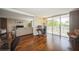 Home office with hardwood floors, desk, and chair, with view of living room and balcony at 2630 Pearce Dr # 404, Clearwater, FL 33764
