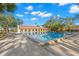 Community pool with lounge chairs and a clubhouse at 2630 Pearce Dr # 404, Clearwater, FL 33764