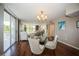 Elegant dining area with glass-top table and modern chairs near living room at 2630 Pearce Dr # 404, Clearwater, FL 33764