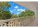 Spacious balcony overlooking lush green trees and a partly cloudy sky at 2630 Pearce Dr # 404, Clearwater, FL 33764