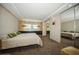 Spacious bedroom with mirrored closet doors and plush carpeting at 2630 Pearce Dr # 404, Clearwater, FL 33764