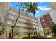 Condo building with courtyard, palm trees, and balconies at 2630 Pearce Dr # 404, Clearwater, FL 33764