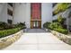 Inviting entrance to a condo building with landscaping and walkway at 2630 Pearce Dr # 404, Clearwater, FL 33764