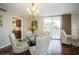 Bright dining area with glass table and chairs, hardwood floors, and access to balcony at 2630 Pearce Dr # 404, Clearwater, FL 33764