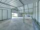 Large workshop with a roll-up door and concrete floor at 4608 Holbrook Rd, Plant City, FL 33565