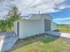 Detached barn with a large roll-up door and additional storage area at 4608 Holbrook Rd, Plant City, FL 33565