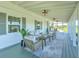 Relaxing front porch with seating, fans, and a view of the yard at 4608 Holbrook Rd, Plant City, FL 33565