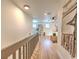 Light-filled hallway with wood floors and modern railing at 4608 Holbrook Rd, Plant City, FL 33565