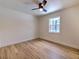 Well-lit bedroom featuring wood floors and a window with a view at 4608 Holbrook Rd, Plant City, FL 33565
