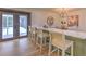 Kitchen island with white quartz countertop and four woven chairs, overlooking pool at 4608 Holbrook Rd, Plant City, FL 33565