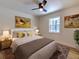 Bright bedroom with a queen-size bed, wood floors, and large windows at 4608 Holbrook Rd, Plant City, FL 33565