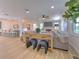 Open concept living room with a stone fireplace and hardwood floors, showing the kitchen at 4608 Holbrook Rd, Plant City, FL 33565