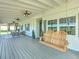 Spacious front porch with ceiling fans and comfortable seating at 4608 Holbrook Rd, Plant City, FL 33565