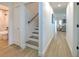Clean hallway with wood-look floors and access to a full bathroom and stairs at 4608 Holbrook Rd, Plant City, FL 33565