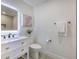 Clean bathroom with a white vanity, toilet, and a large mirror at 4608 Holbrook Rd, Plant City, FL 33565