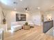 Spacious loft area with two white armchairs, a round coffee table, and hardwood floors at 4608 Holbrook Rd, Plant City, FL 33565