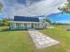 White farmhouse with a wraparound porch and stone walkway, on a large lot at 4608 Holbrook Rd, Plant City, FL 33565