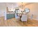 Bright dining area with a wood table, light gray chairs, and a modern chandelier at 4608 Holbrook Rd, Plant City, FL 33565