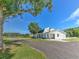 White farmhouse on a large lot with a tree swing and outbuildings at 4608 Holbrook Rd, Plant City, FL 33565