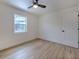 Simple bedroom with wood floors and a window at 4608 Holbrook Rd, Plant City, FL 33565