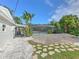 Landscaped side yard with a stone pathway leading to the pool area at 4608 Holbrook Rd, Plant City, FL 33565