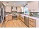 Modern kitchen with white cabinets, farmhouse sink, and stainless steel appliances at 4608 Holbrook Rd, Plant City, FL 33565