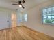 Spacious bedroom with wood floors, and access to a bathroom at 4608 Holbrook Rd, Plant City, FL 33565