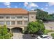 Exterior view of building with arched parking entrance and neatly maintained landscaping at 2331 W Horatio St # 610, Tampa, FL 33609