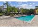 Community pool with lounge chairs and brick deck at 2331 W Horatio St # 610, Tampa, FL 33609