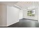 Bright living room with dark gray floors and a large window at 2331 W Horatio St # 610, Tampa, FL 33609