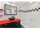 Bathroom with black and white checkered tile and red vanity at 2331 W Horatio St # 610, Tampa, FL 33609