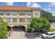 Exterior view of building with arched parking entrance and neatly maintained landscaping at 2331 W Horatio St # 610, Tampa, FL 33609